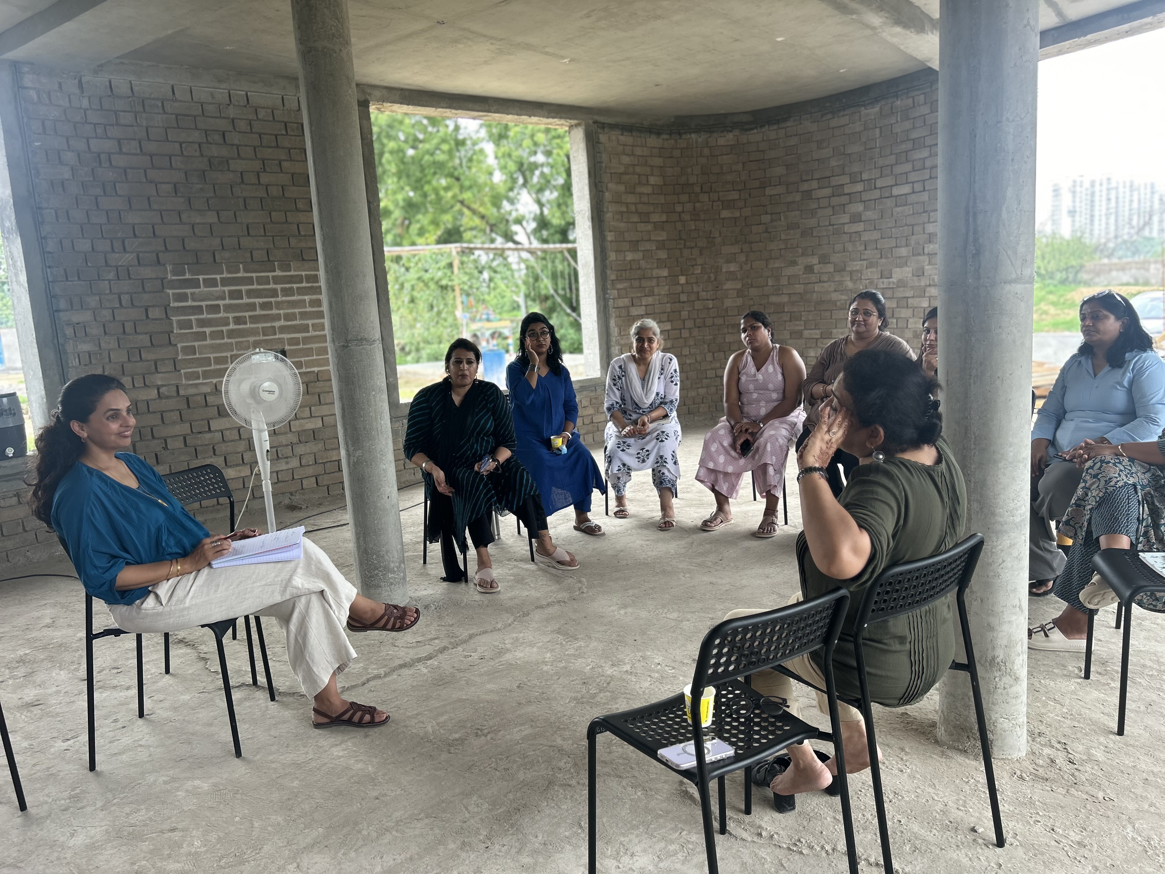 First story charrette, circle discussion at aTaleier construction site